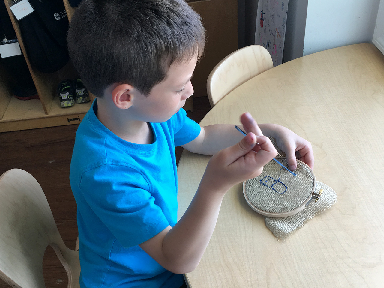 A Lower Elementary student sewing